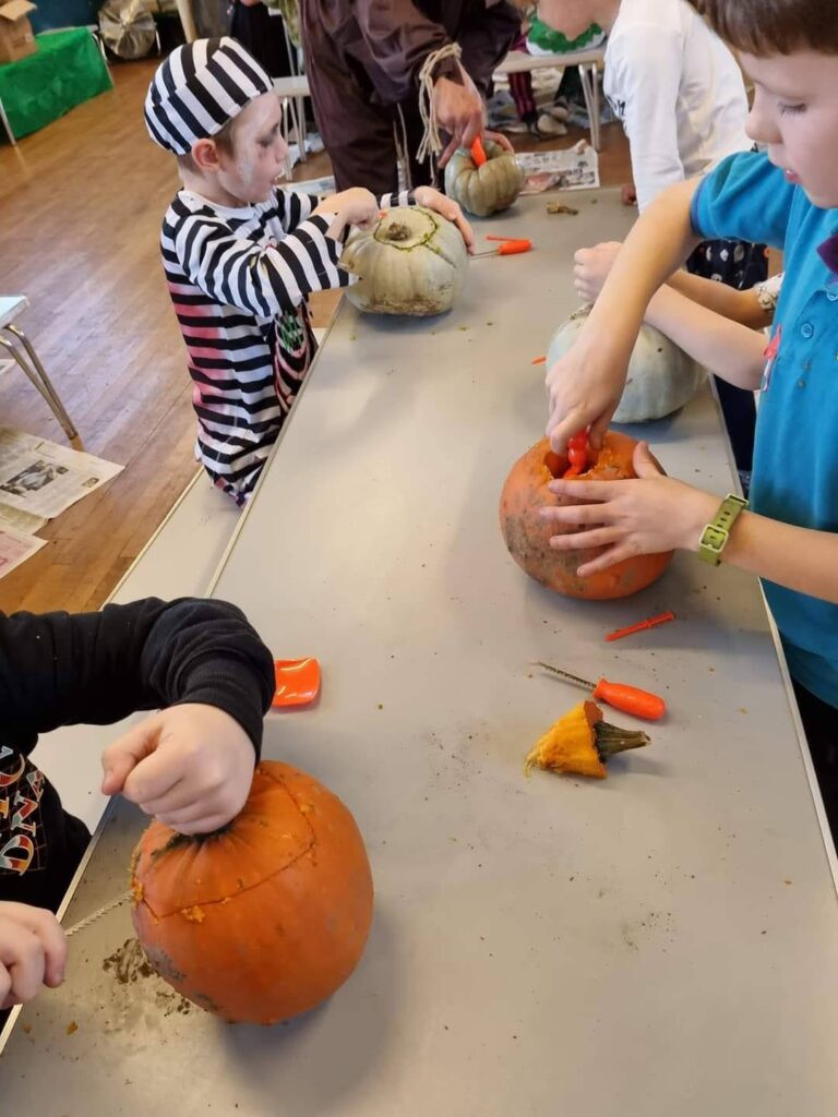 Beavers carving Halloween pumpkins